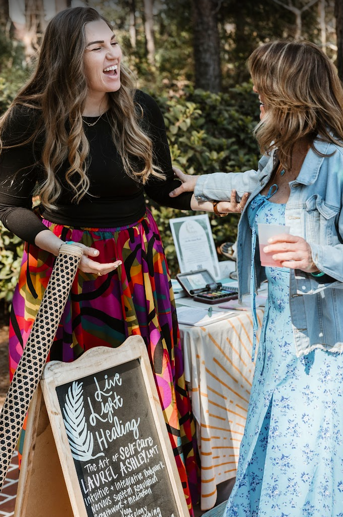 Laurel laughing with a guest at a Lowcountry wellness event
