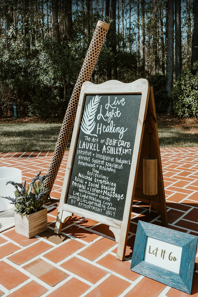 Live Light Healing chalkboard sign listing bodywork, reiki, and sound healing services